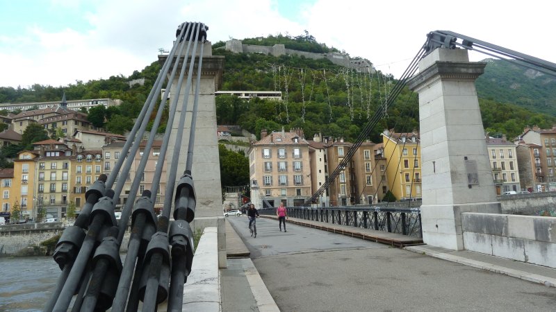Pedestrian bridge over the Isere, looking up to the Bastille in Grenoble.